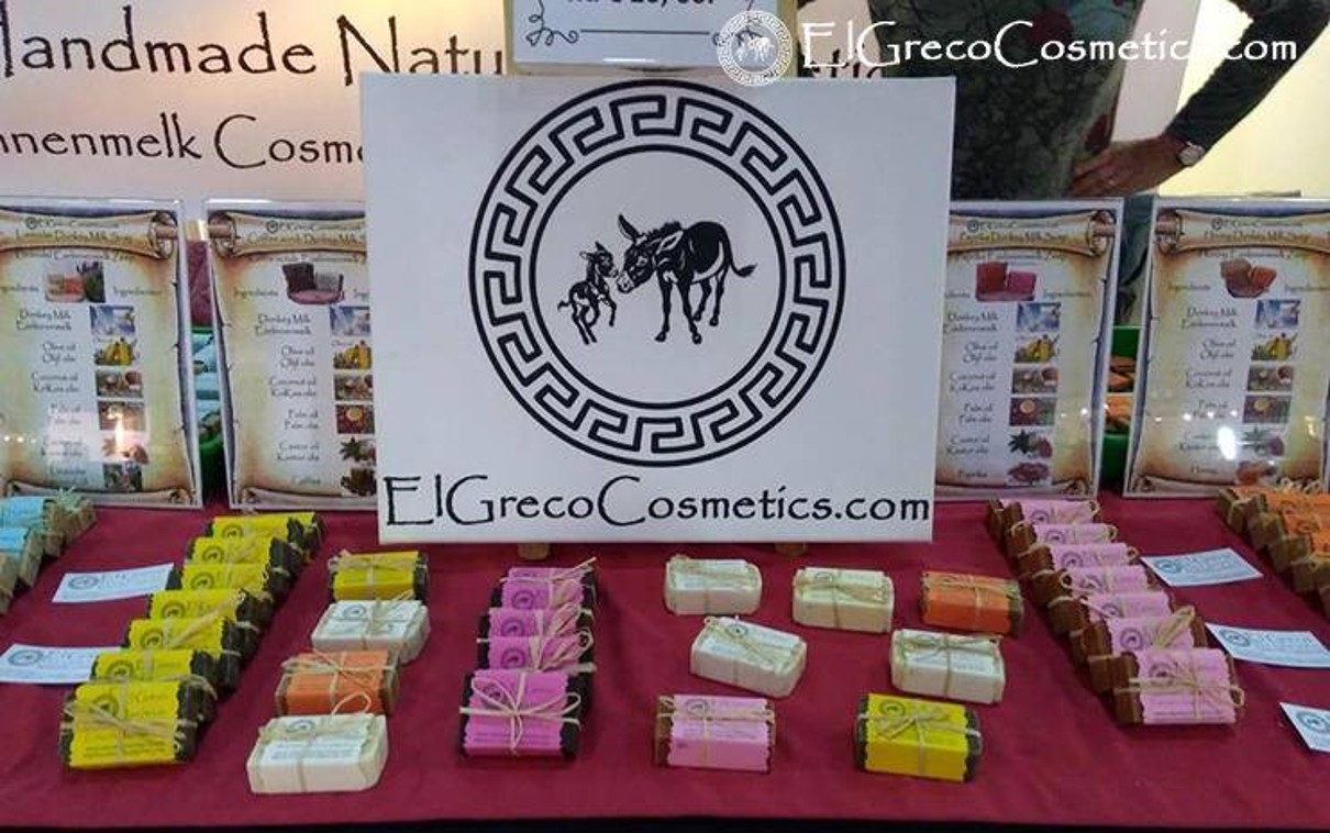 Soaps on a table, in the background the logo of the exhibitor El Greco Cosmetics can be seen. 