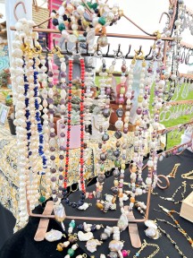 Perlenschmuck in verschiedenen Farben an einem Schmuckständer.