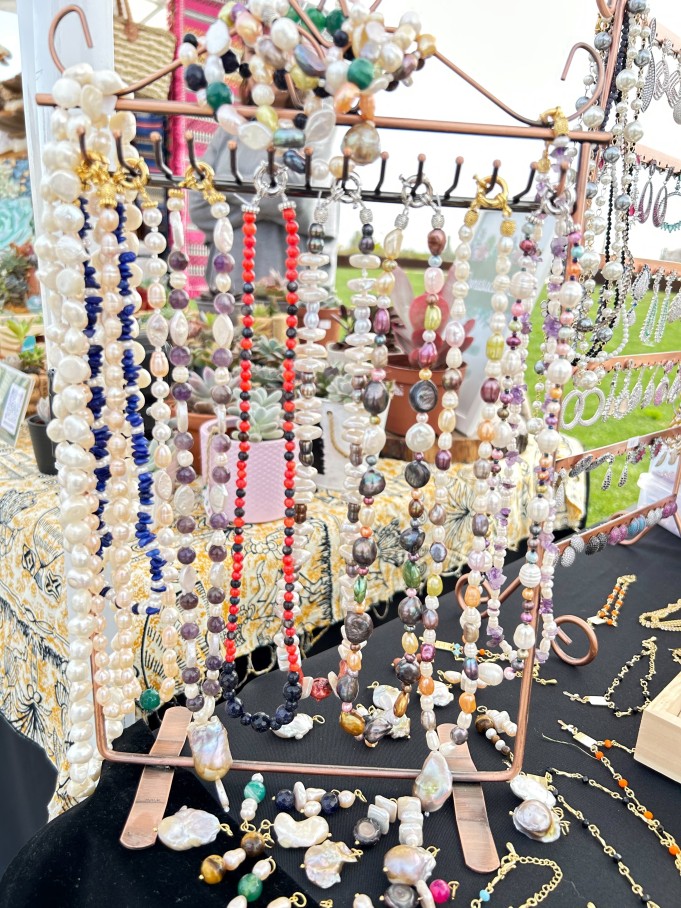 colorful jewellery with pearls at a stand. 
