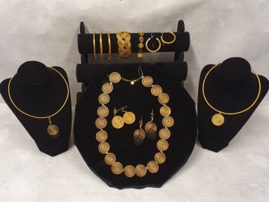 Gold jewellery on display in various forms.