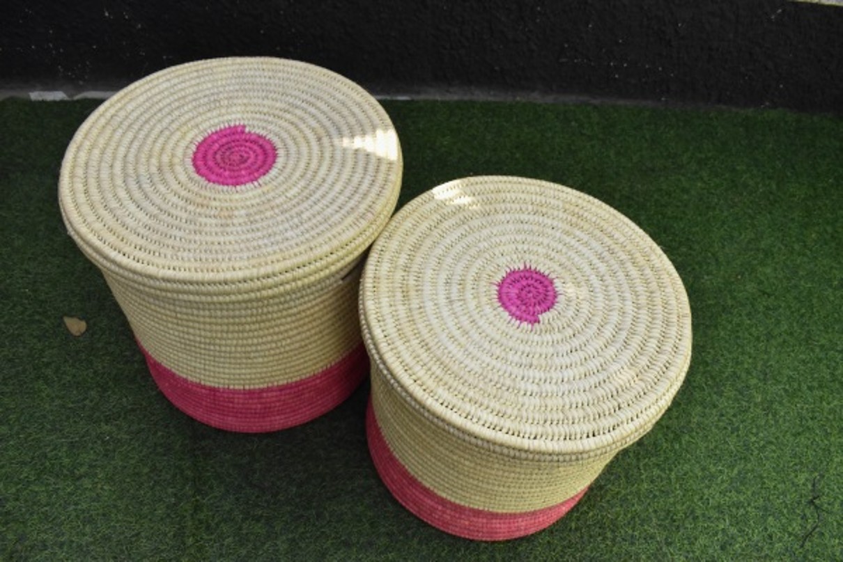 Baskets with lids standing on green bottom