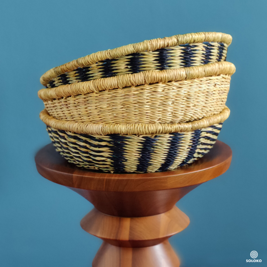 Woven baskets stand on a wooden table, the background is blue.